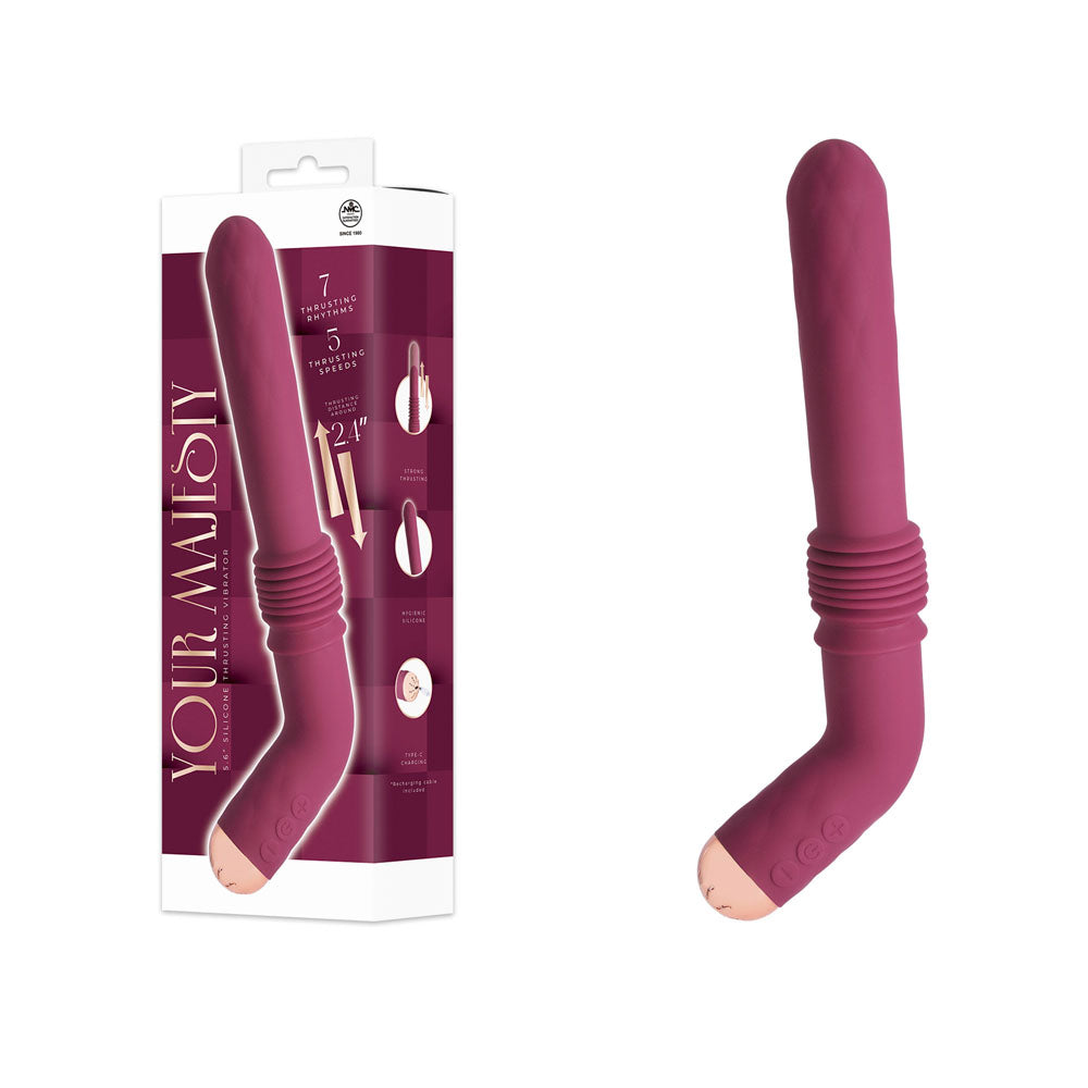 A curved, angled adult novelty massager in a muted berry pink color, shown both next to its retail packaging box and standing alone on a plain white background. The packaging features the brand name 'YOUR MAJESTY'.