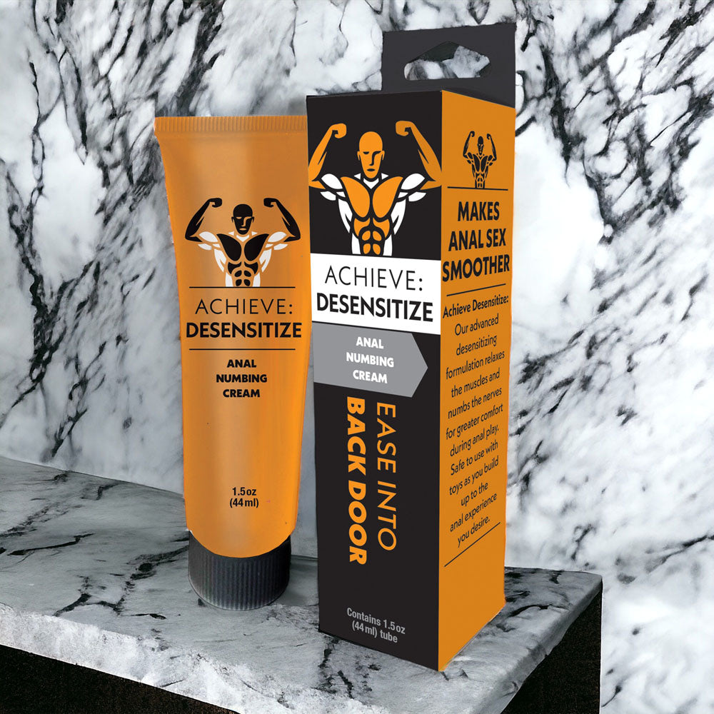 Achieve Desensitize anal numbing cream tube and retail box displayed on marble surface against marbled background