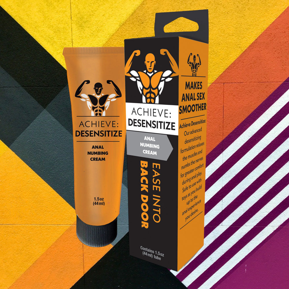 Achieve Desensitize cream tube and packaging box shown against colorful geometric background with yellow and purple stripes