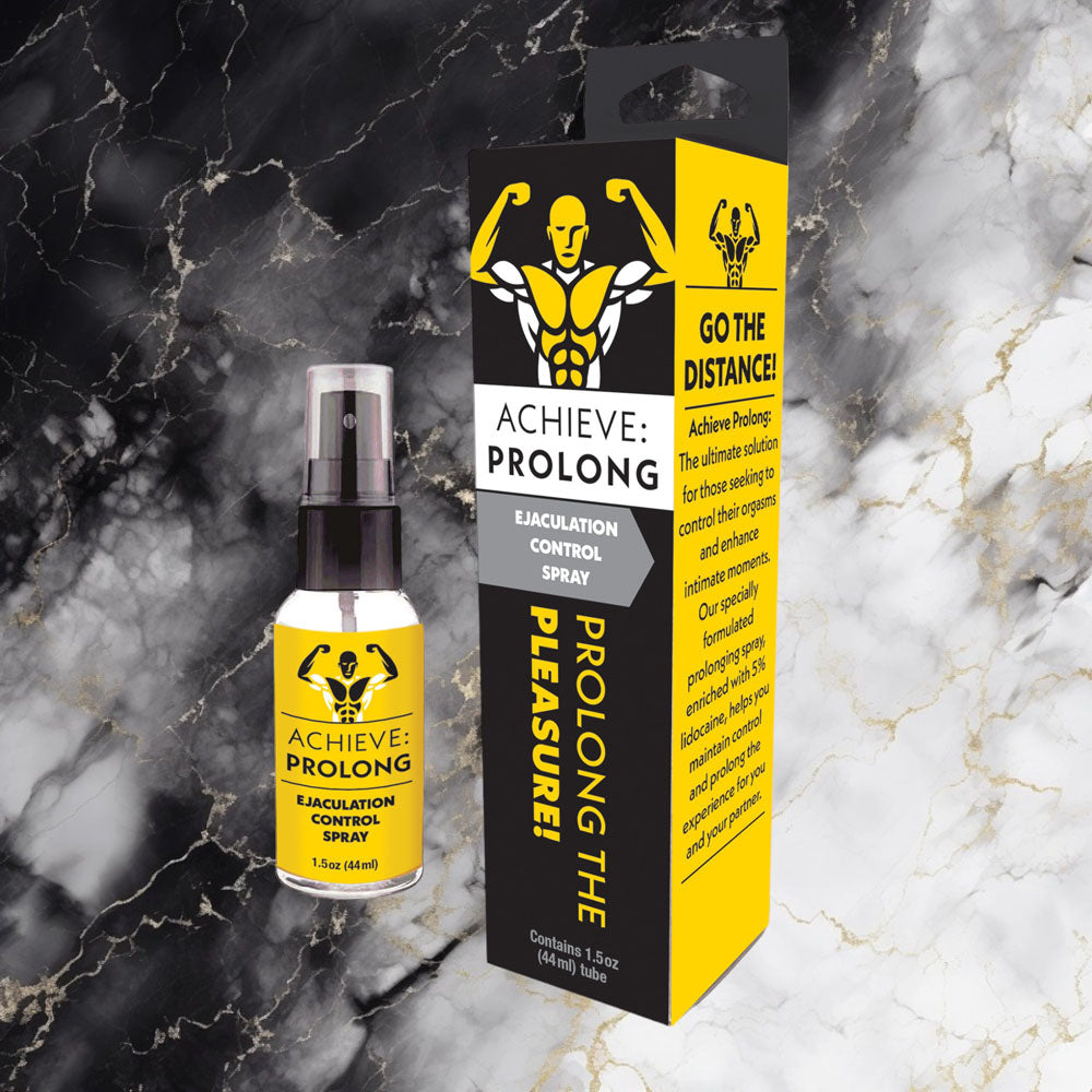 Achieve Prolong male enhancement spray bottle and packaging displayed on marble background with yellow and black design