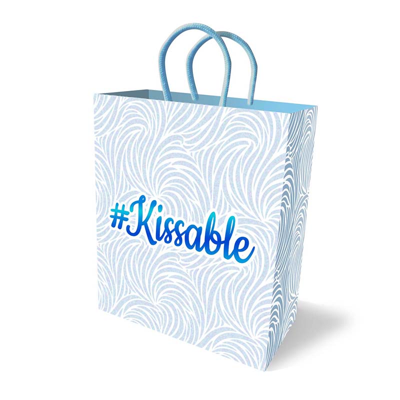 Kissable gift bag in pastel blue with swirl pattern and blue handles, featuring elegant Kissable text on white background