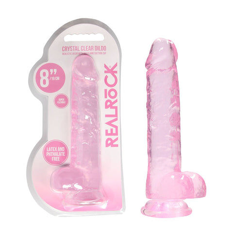 Translucent pink RealRock eight inch dildo shown in blister pack and standing on its suction base.