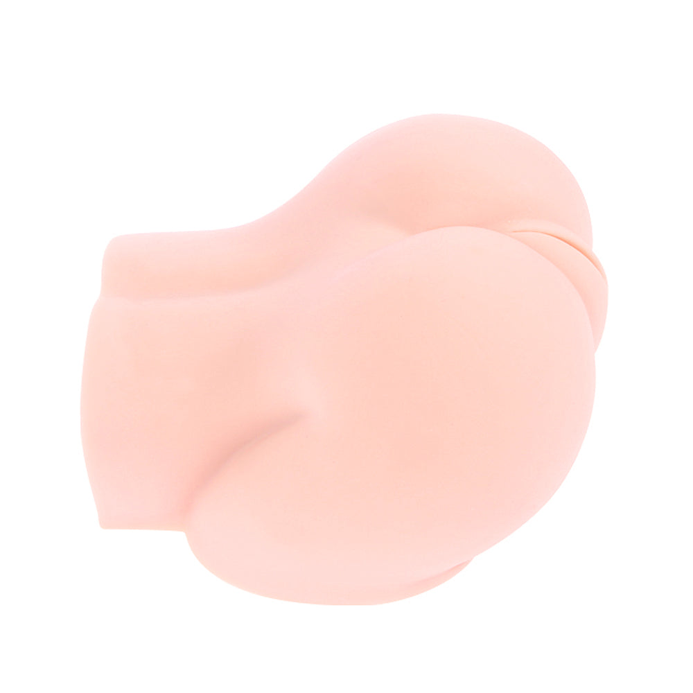 Soft peach silicone masturbator shaped like firm buttocks, shown from a rear side angle.