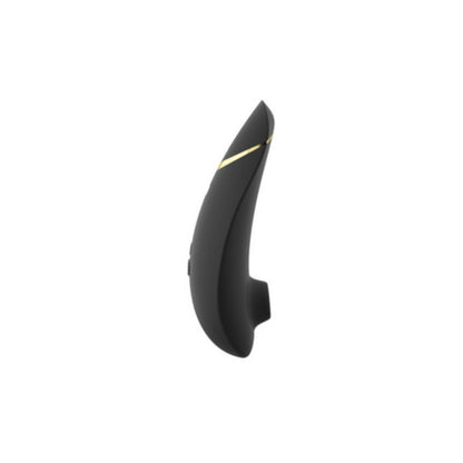 A black Womanizer Premium 2 clitoral stimulator with gold accents appears next to its matching box, displaying the Womanizer brand, product name, tagline "Define your luxury," and highlighting advanced Pleasure Air Technology.